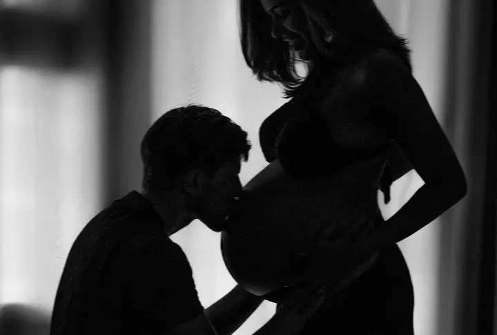 Man kissing pregnant woman's belly