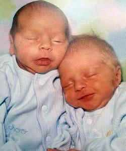 twins sleeping and smiling