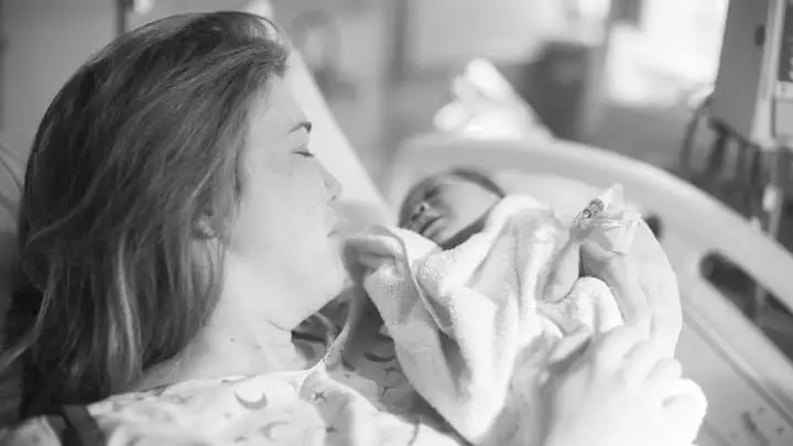 Mom in hospital bed with newborn baby