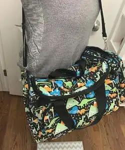 mom carrying twin gear diaper duffle bag