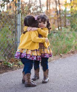 Identical twin girls hugging